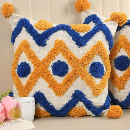 Set of 2 mustard tufted cushion covers with tassels by The Gharnish, featuring soft fabric and decorative tassel accents.