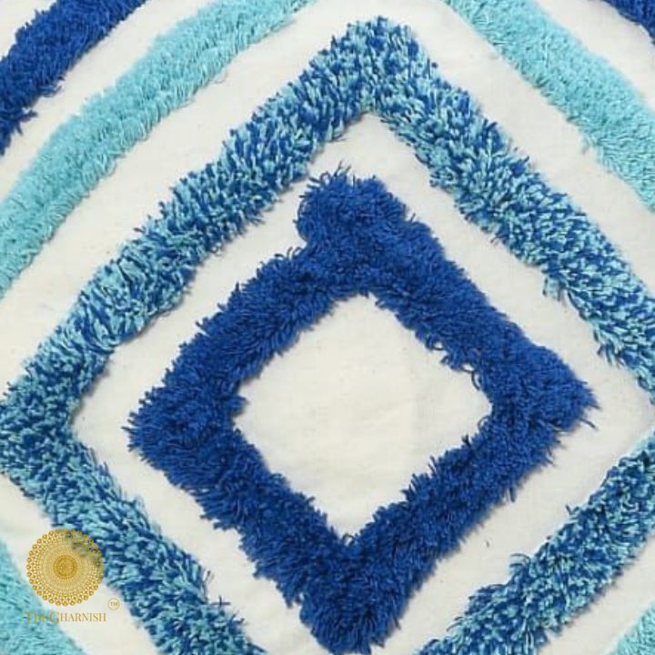 Set of two handcrafted white and blue tassel cushions by The Gharnish, featuring decorative tassels and soft fabric.