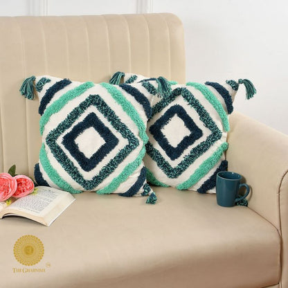 Set of two handcrafted white and blue tassels cushions by The Gharnish, featuring decorative tassel accents and soft fabric.