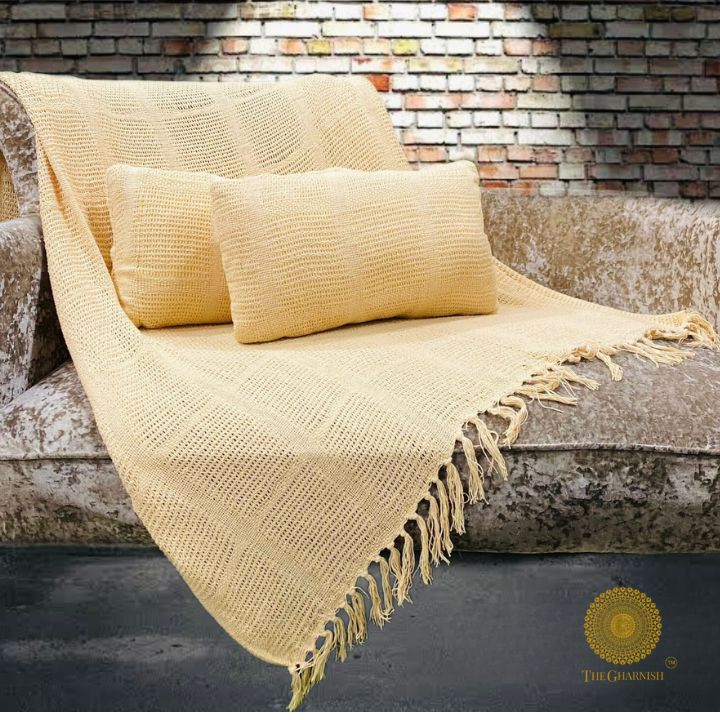 Textured knitted throw and cushion set by The Gharnish, featuring super-soft lightweight fabric and cozy decorative pillows.
