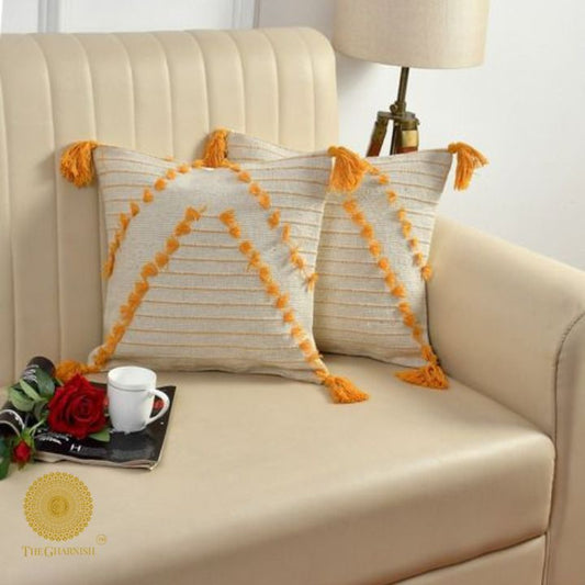 Set of two yellow tassel cushion covers by The Gharnish, handcrafted with decorative tassels, perfect for stylish home decor.