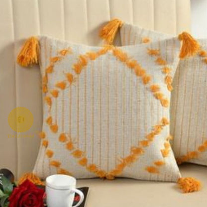 Set of two yellow handcrafted cushion covers with tassels by The Gharnish, stylish and decorative cushions for home decor.