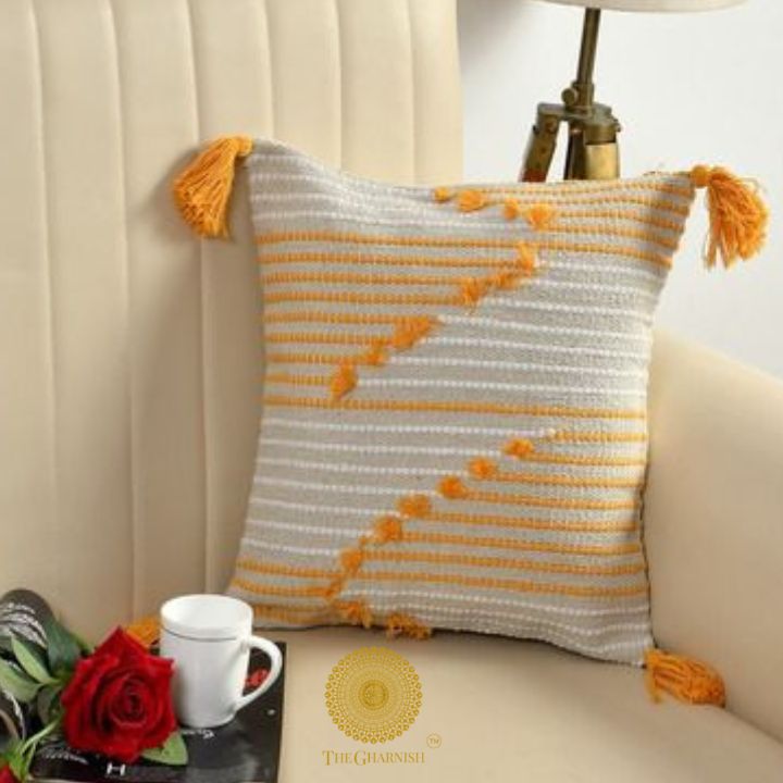 Set of two yellow handcrafted cushion covers with tassels by The Gharnish, featuring a stylish and decorative design.
