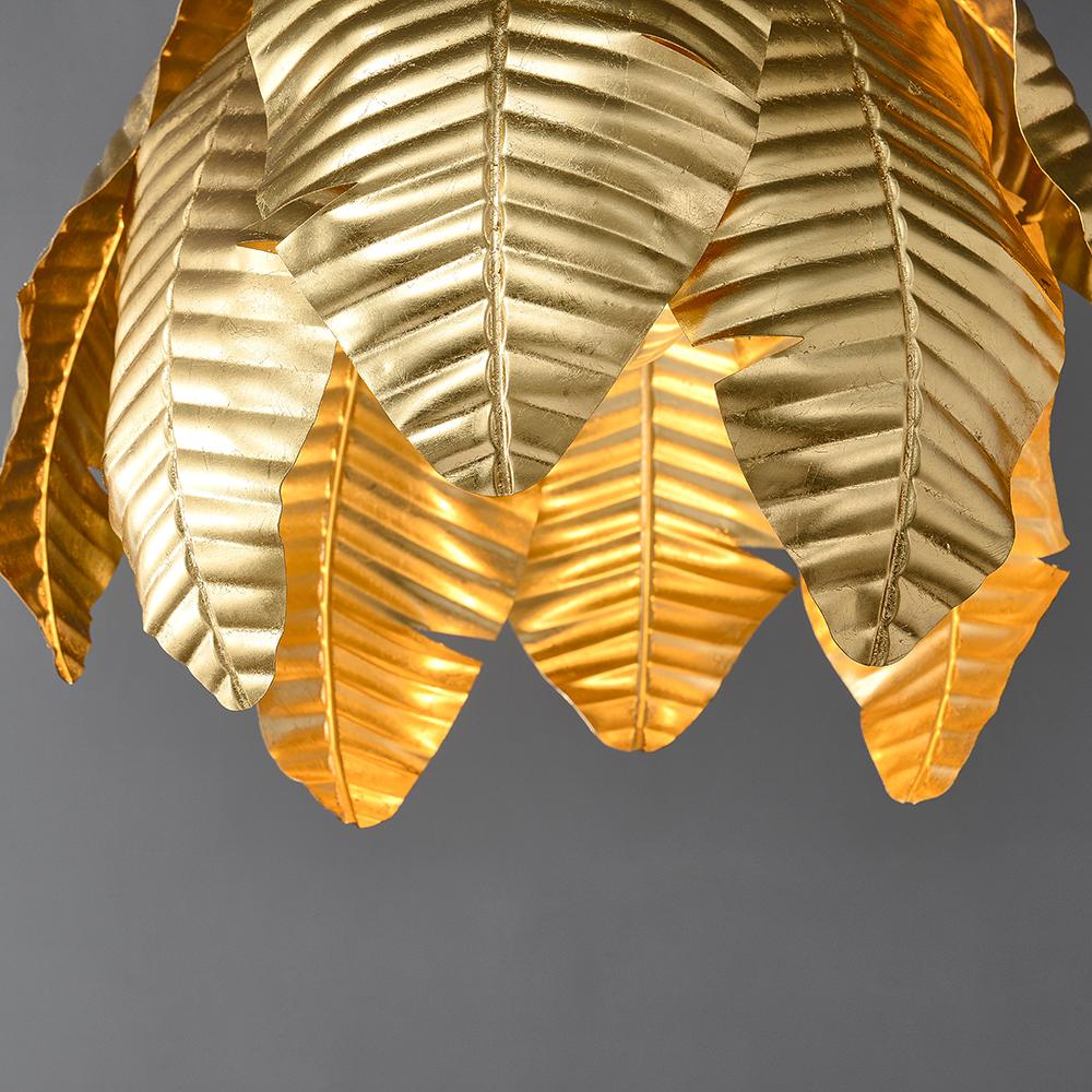 Gold palm leaf hanging pendant light by The Gharnish, decorative floor lamp with tropical leaf design and warm gold finish.