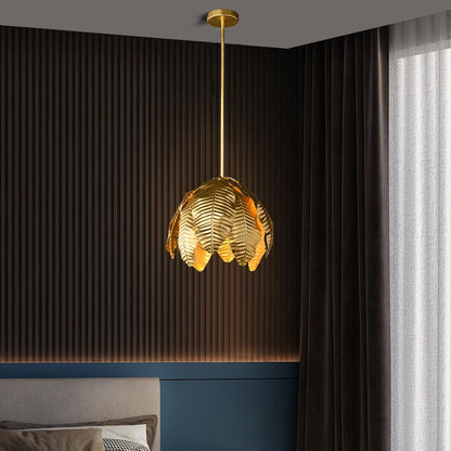 Gold palm leaf hanging pendant light by The Gharnish, stylish floor lamp with intricate leaf design and warm gold finish.