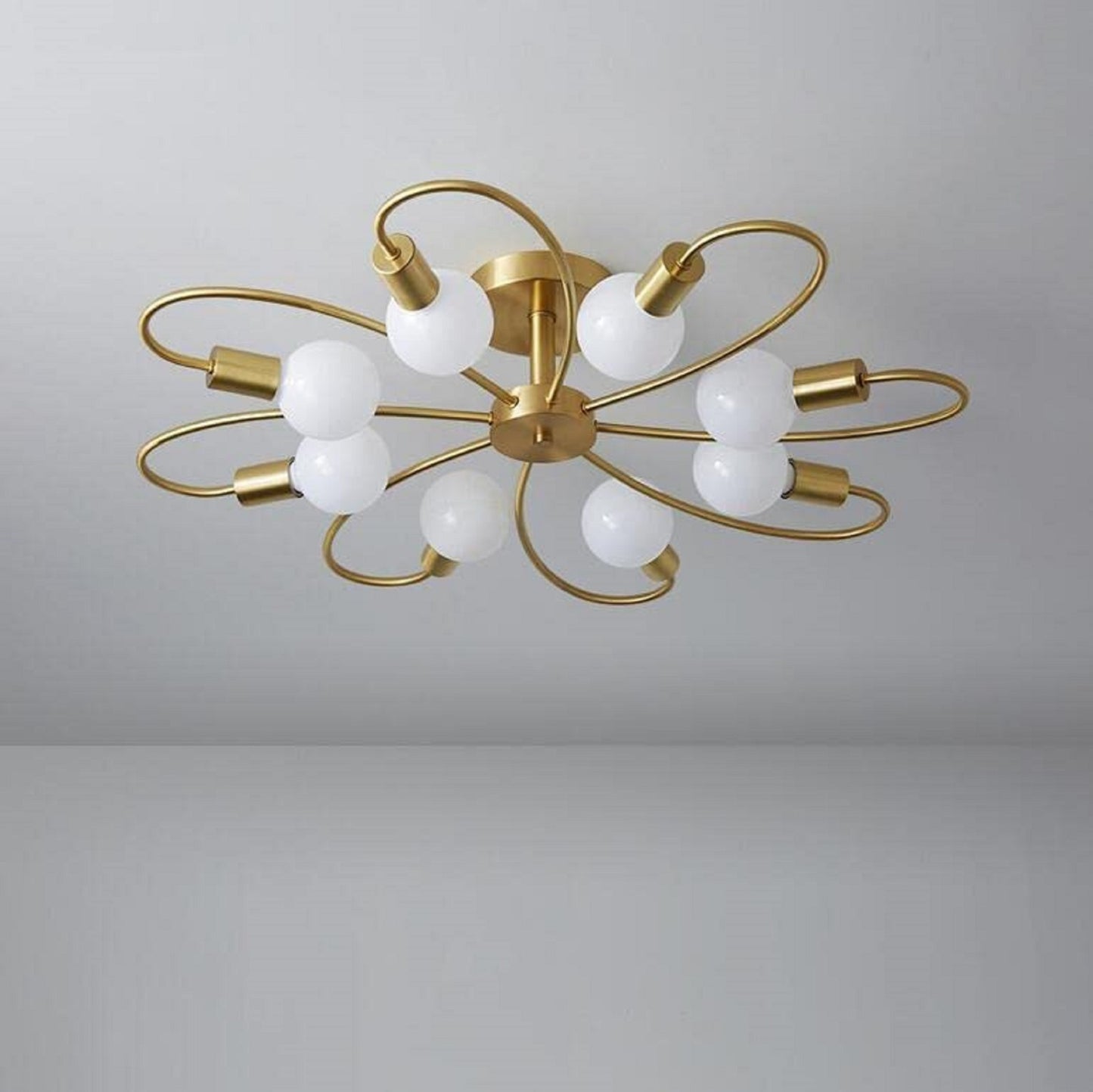 Gold metal ceiling pendant chandelier light from The Gharnish, designed as a stylish floor lamp with elegant hanging fixtures.
