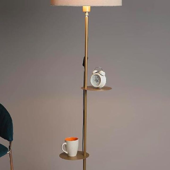 Modern gold metal floor lamp by The Gharnish, designed for living rooms, with a sleek contemporary style and adjustable arm.