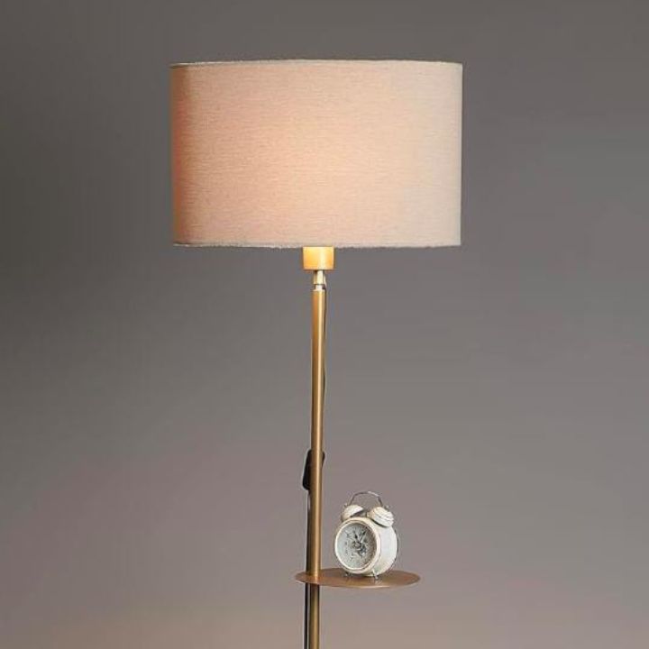 Modern gold metal floor lamp by The Gharnish, stylish floor lighting for living room decor with a sleek contemporary design.