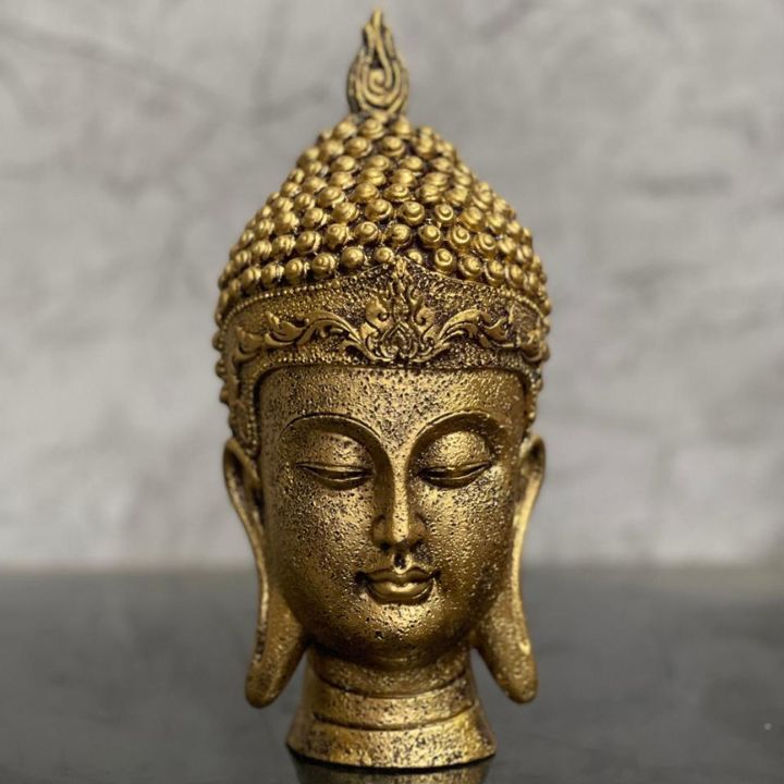 Gold-colored Buddha face figurine by The Gharnish, suitable for home and office Vastu, detailed and serene decorative gods showpiece.