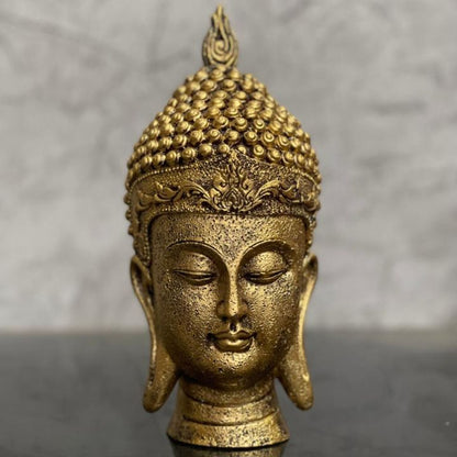 Gold-colored Buddha face figurine by The Gharnish, suitable for home and office Vastu, detailed and serene decorative gods showpiece.