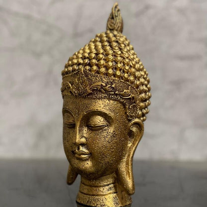 Gold-colored Buddha face showpiece for home and office, Vastu-friendly gods figurine by The Gharnish.