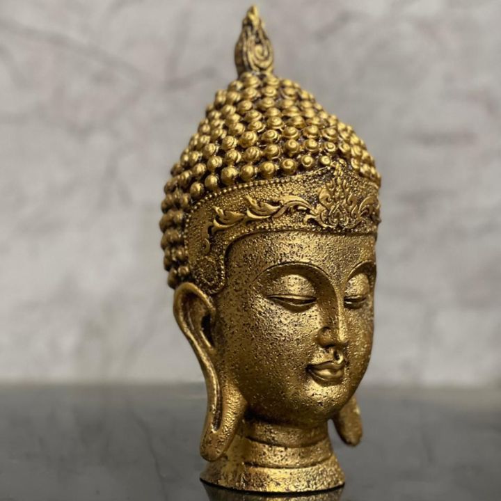 Golden Buddha face showpiece, a Gods figurine by The Gharnish, ideal for home and office Vastu decoration.