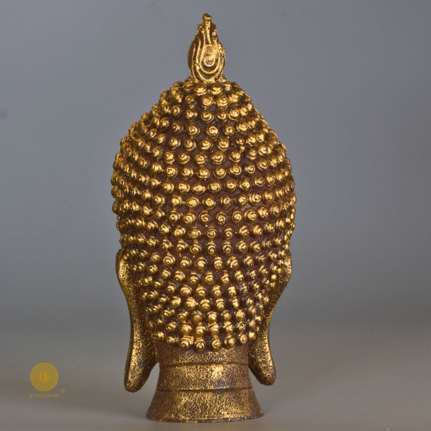 Gold-colored Buddha face figurine by The Gharnish, decorative showpiece for home and office Vastu and spiritual decor.
