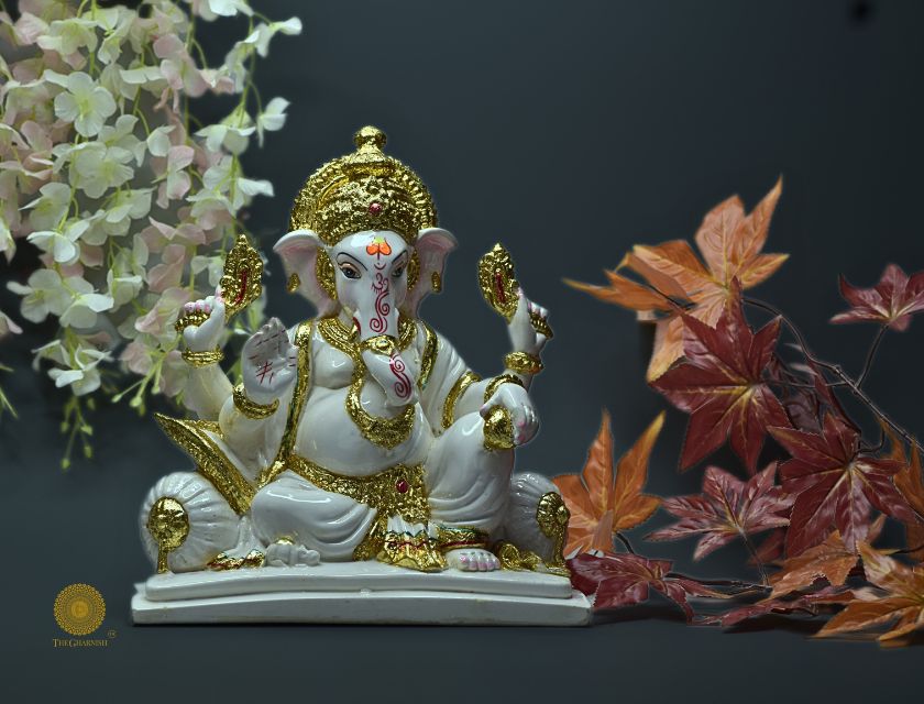 White marble Lord Ganesha statue, a Hindu gods figurine by The Gharnish, showcasing intricate carvings and a serene expression.