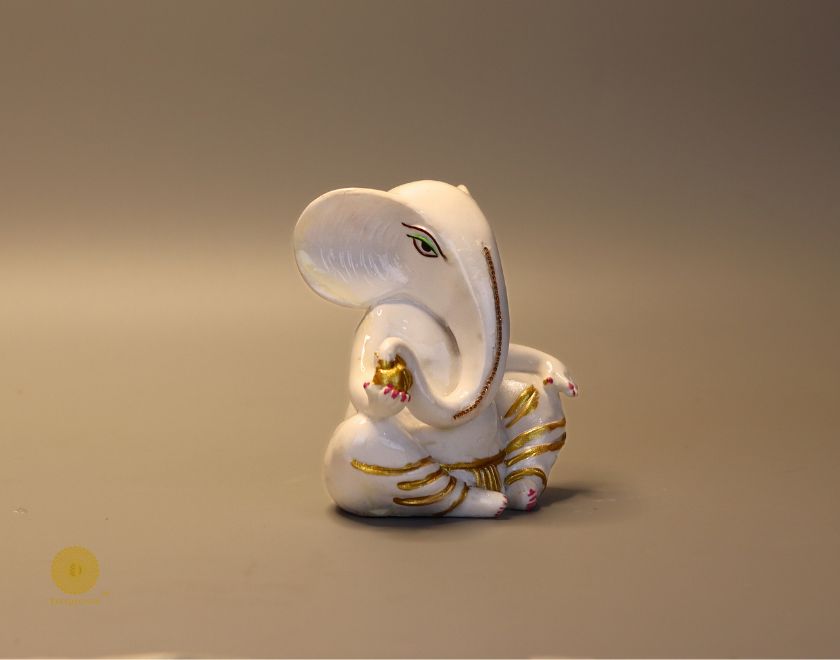 Left side view of The Gharnish Vaastu Ganesha statue, a detailed gods figurine with intricate carvings and traditional design.