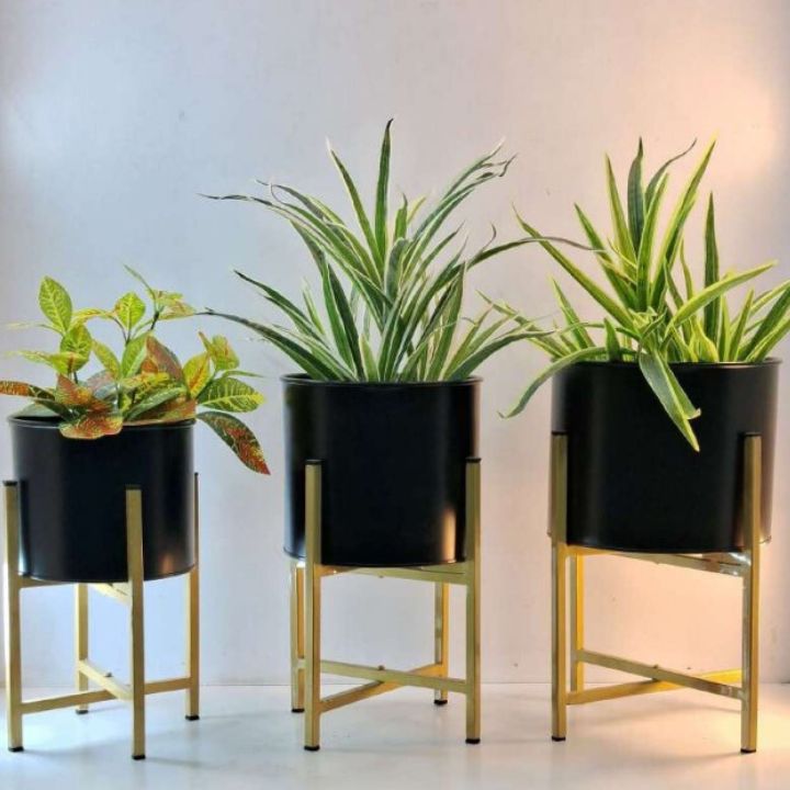 Set of three metal planters with stands from The Gharnish, suitable for home or office decor.