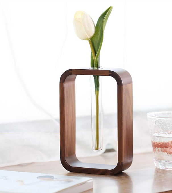 Wooden holder with a cylindrical planter tube from The Gharnish, ideal for indoor or outdoor plant display.