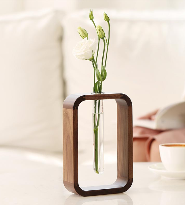 Wooden holder with a sleek planter tube from The Gharnish, ideal for indoor plants or decorative greenery.
