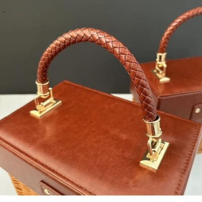 Small souvenir leather and rattan storage basket by The Gharnish, with a woven design and compact storage solution.