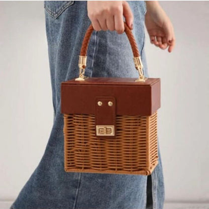 Small leather and rattan storage basket by The Gharnish, perfect for organizing souvenirs and small items.