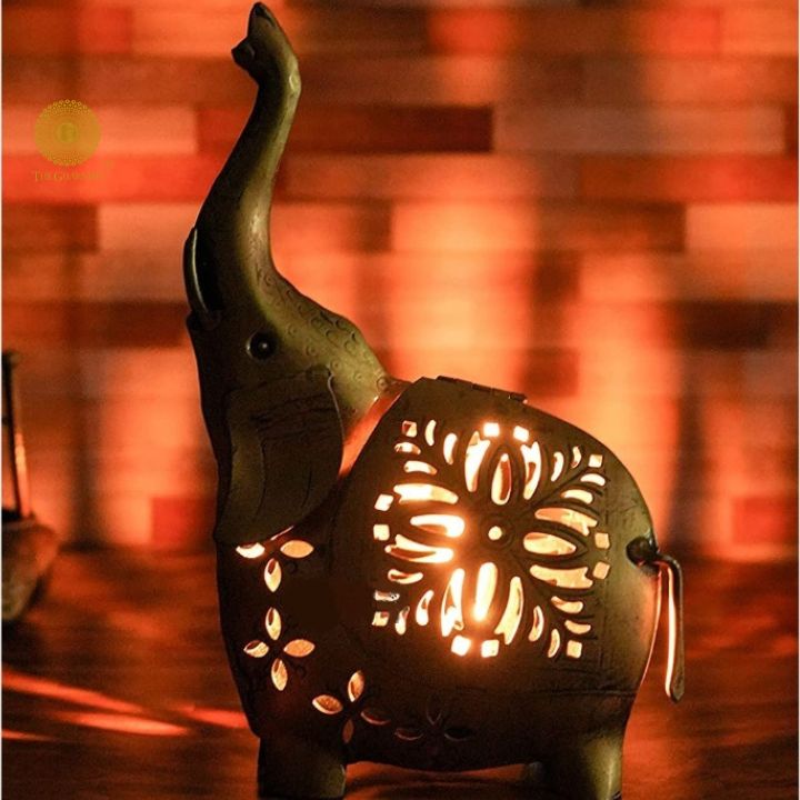 Gold painted T-light elephant table decor by The Gharnish, elegant tabletop ornament with a decorative elephant design and T-light holder.