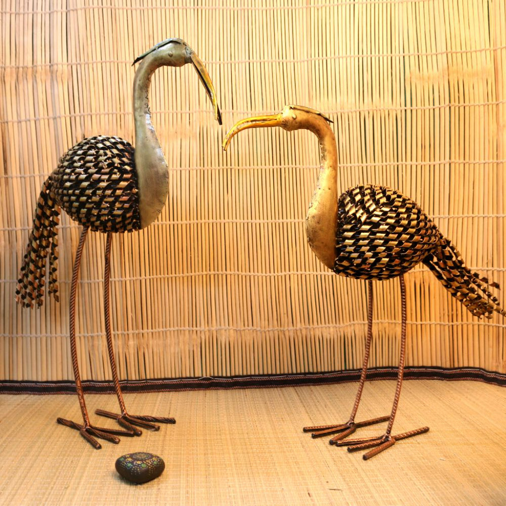 Set of two iron-painted crane tea light holders for table decor, featuring intricate crane designs by The Gharnish.