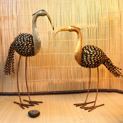 Set of two iron-painted crane tea light holders for table decor, featuring intricate crane designs by The Gharnish.