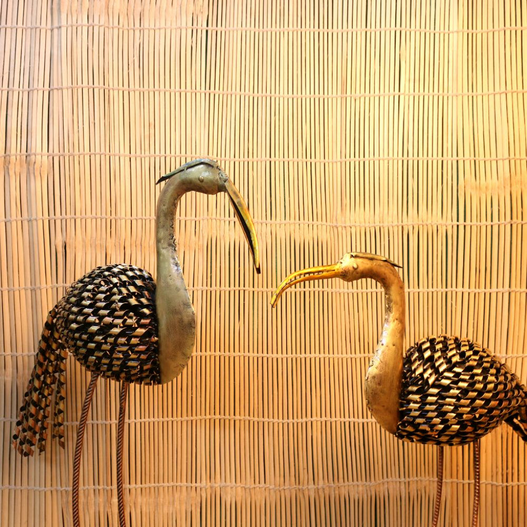 Set of two iron-painted crane tea light holders for table top decor, featuring intricate crane designs by The Gharnish.