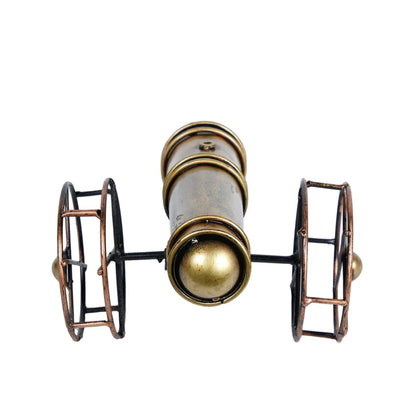 Metal cannon table decor from The Gharnish, a stylish tabletop accent with intricate metal detailing for display.