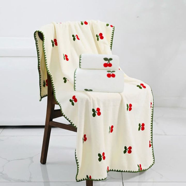Set of embroidered full-size bath towel and hand towel from The Gharnish, soft and absorbent with decorative embroidery.