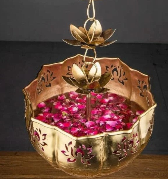 Set of two hanging lotus-shaped Urli by The Gharnish, decorative metal bowls with intricate designs for home decor.