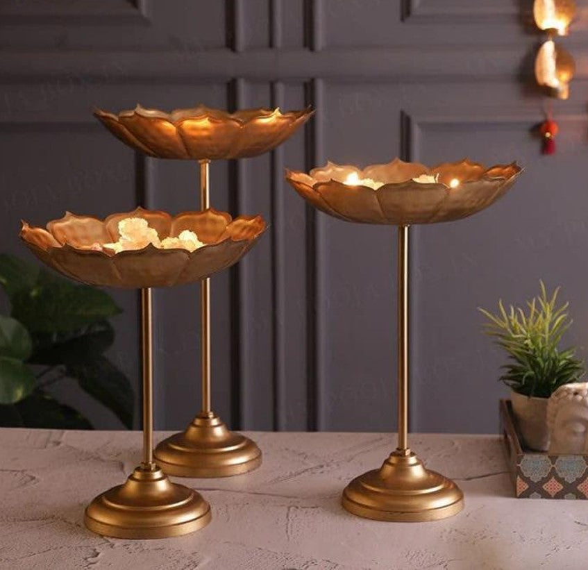 Set of three gold Lotus Urli bowls with stands by The Gharnish, elegant traditional serving and decorative pieces.