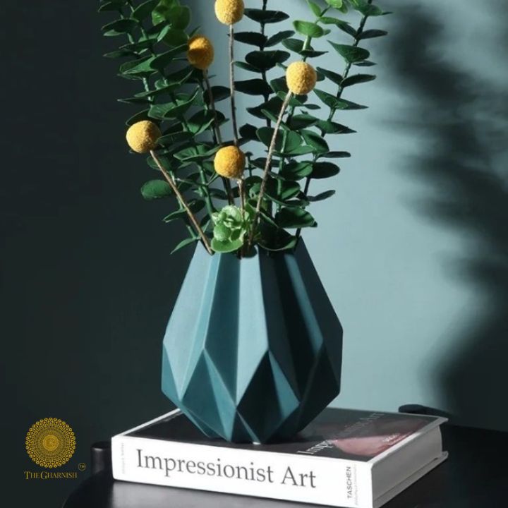 Small black ceramic vase shaped like a lotus flower by The Gharnish, perfect for decorative floral arrangements.