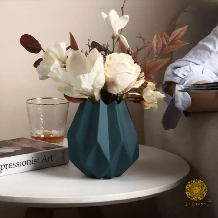 Small black ceramic vase shaped like a lotus flower by The Gharnish, showcasing intricate petal details and elegant design.