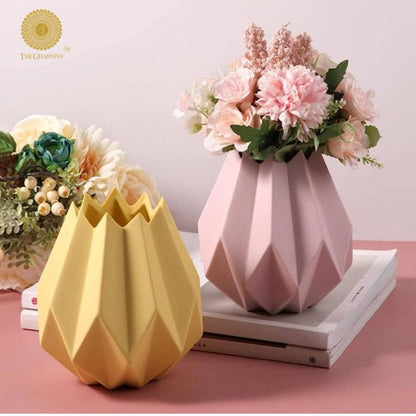 Small black ceramic vase shaped like a lotus flower by The Gharnish, featuring elegant floral design and smooth finish.