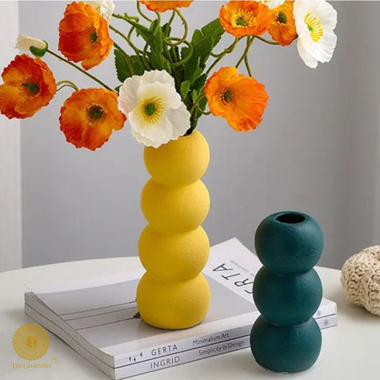 Elegant modern ceramic vase by The Gharnish, featuring artistic design and smooth surface, perfect for contemporary home decor.