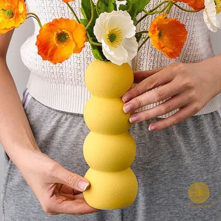 Elegant modern ceramic vase by The Gharnish, featuring artistic design and sleek shape for contemporary home decor.