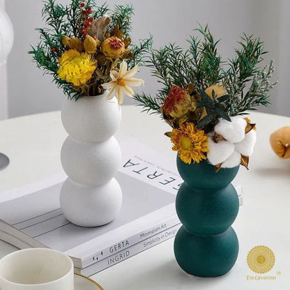 Elegant modern ceramic vase by The Gharnish, featuring artistic design and sleek shape, perfect for contemporary home decor.