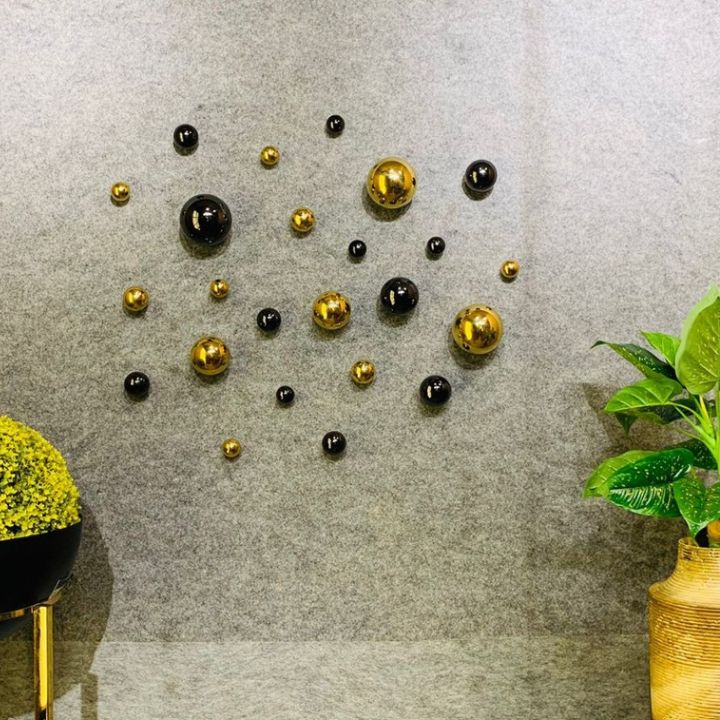 Two PVD coated decorative metallic balls arranged on modern wall art display, featuring sleek, reflective surfaces for stylish wall décor.