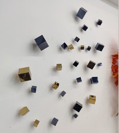 Modern metallic wall art featuring PVD coated square decorative balls by The Gharnish, ideal for contemporary interior décor.