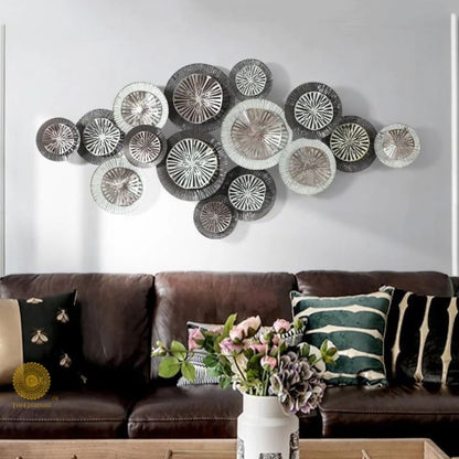 Metallic circles wall art by The Gharnish featuring 15 silver and gold metal discs on a 48x24 inch canvas.