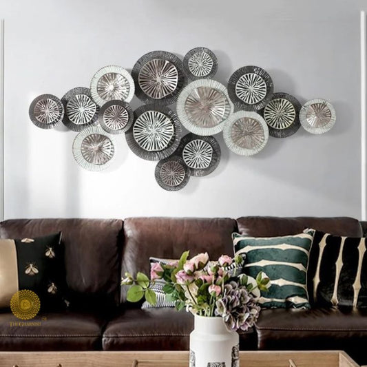 Metallic circles wall art by The Gharnish featuring 15 silver and gold metal discs on a 48x24 inch canvas.