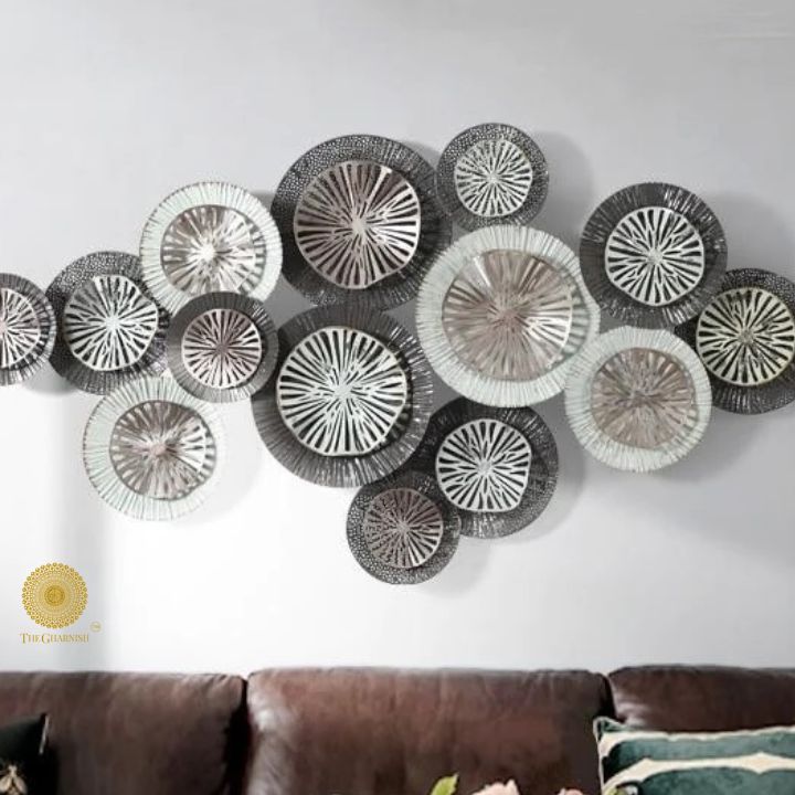Metallic circles wall art by The Gharnish, 48x24 inch modern wall decor with 15 shiny metal circle designs on a neutral background.