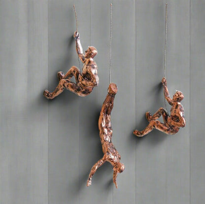 Set of three climbing men wall art decor pieces by The Gharnish, featuring metal wall hangings with intricate climbing figure designs.