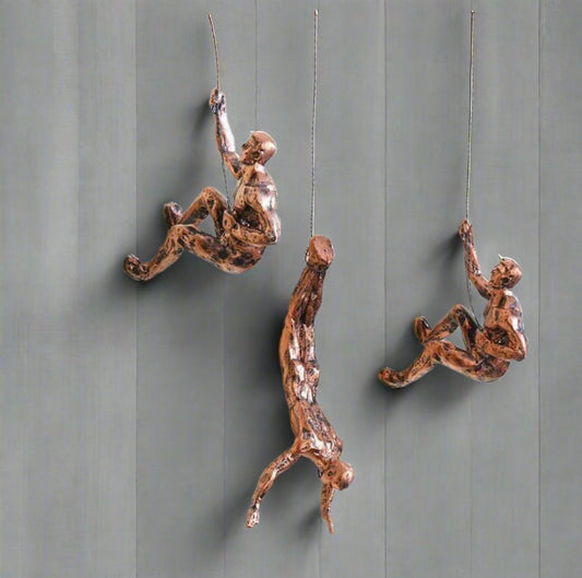 Set of three climbing men wall art decor pieces by The Gharnish, featuring metal wall hangings with intricate climbing figure designs.