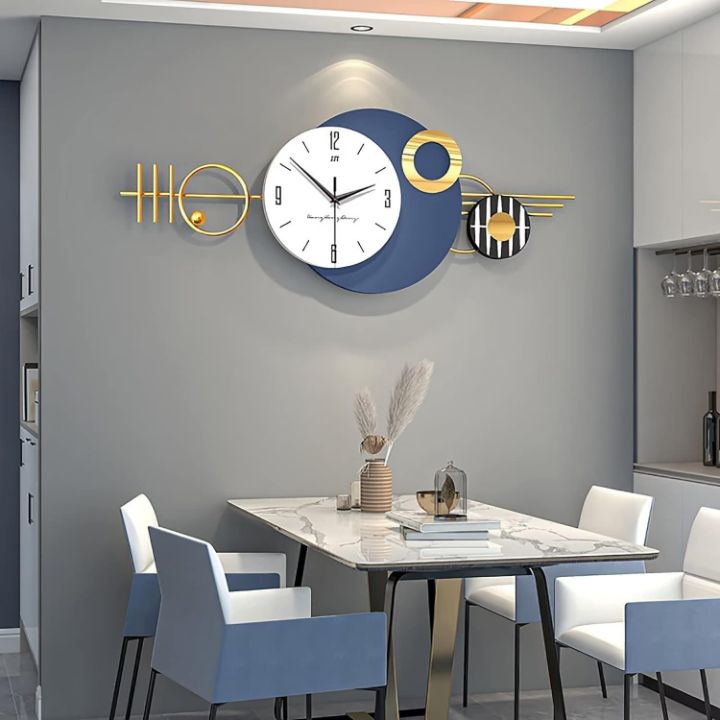 Arial Metallic Wall Clock by The Gharnish, 48x20 inches, showcasing a sleek, modern design with metallic finish for wall decoration.