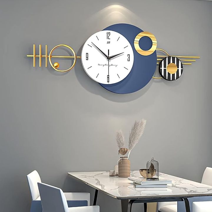 Arial Metallic Wall Clock by The Gharnish, 48x20 inches, featuring a sleek metallic finish and modern wall clock design.