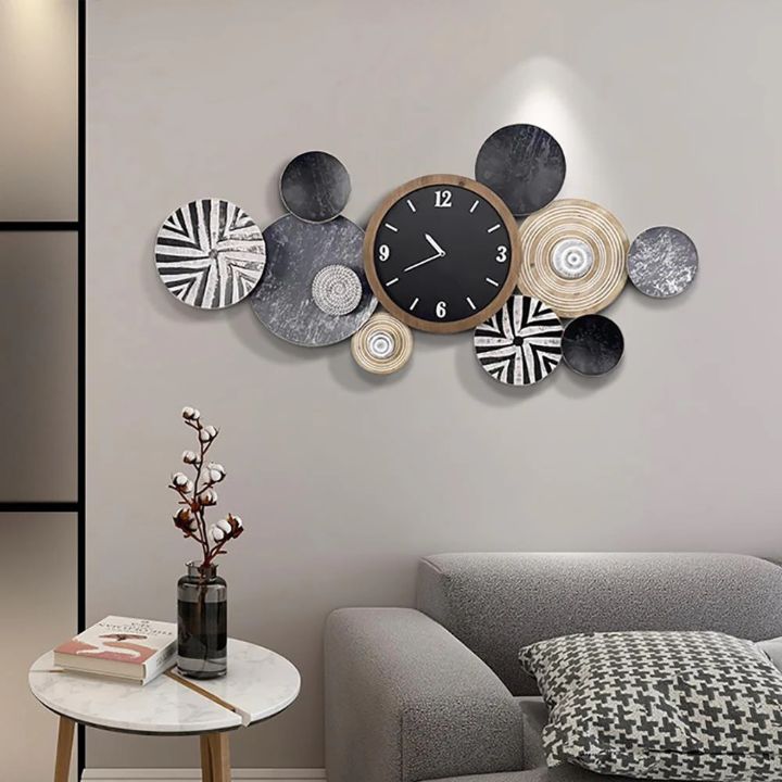 Artistic black abstract circles wall clock by The Gharnish, 48x22 inches, featuring modern circular design for stylish wall decor.