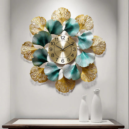 The Gharnish 24-inch circular leaf metallic wall clock with a modern leaf design on a white background.