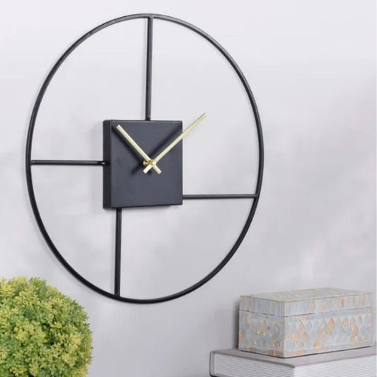 Round metal wall clock with a 24-inch frame by The Gharnish, featuring a sleek modern design and clear clock face.